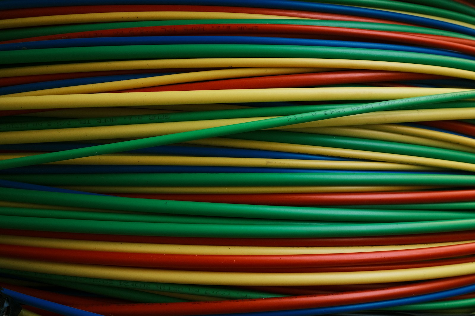 Colorful wires are bundled together, side by side.